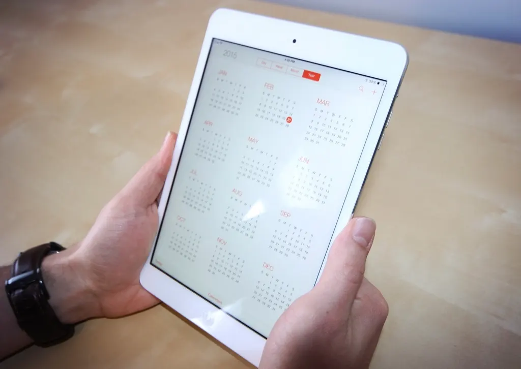 Phone showing a calendar beside a notebook